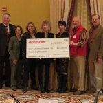 State Farm Insurance presents a check for Help-A-House