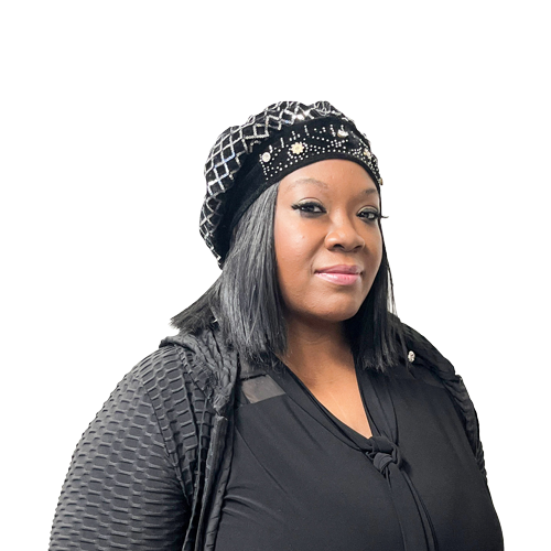 Woman in a stylish black outfit and beanie, looking at the camera with a soft smile, white background.