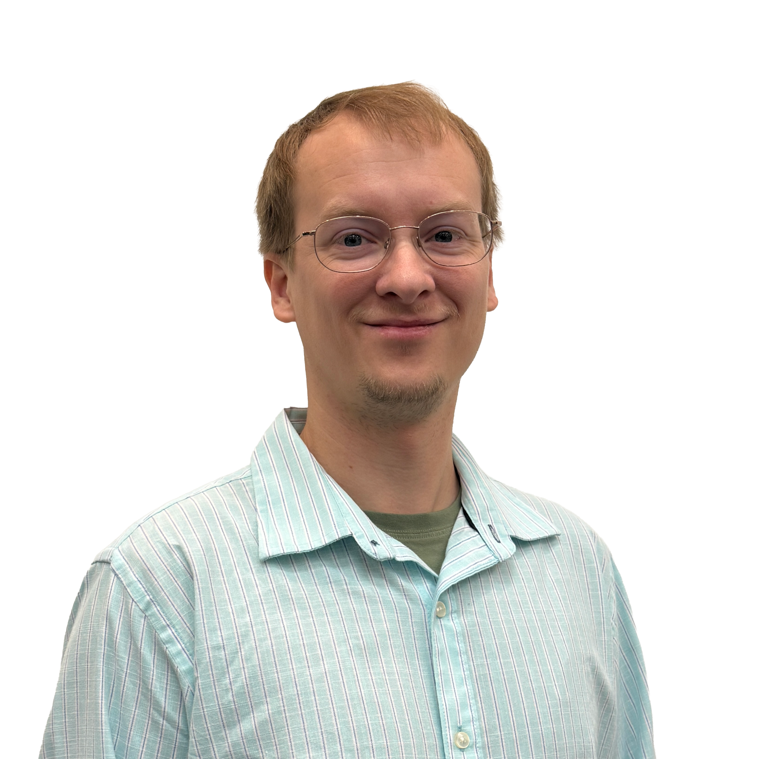 Man with glasses and a light striped shirt smiles slightly, standing against a plain black background.